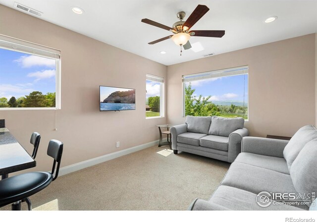 1119 Wrangler Way, Loveland, CO 80537 - carpeted living area with baseboards, ceiling fan, healthy amount of natural light, and recessed lighting