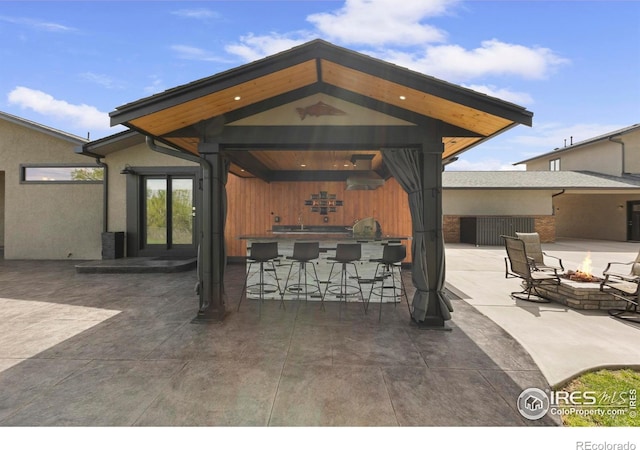 1119 Wrangler Way, Loveland, CO 80537 - view of patio with an outdoor fire pit