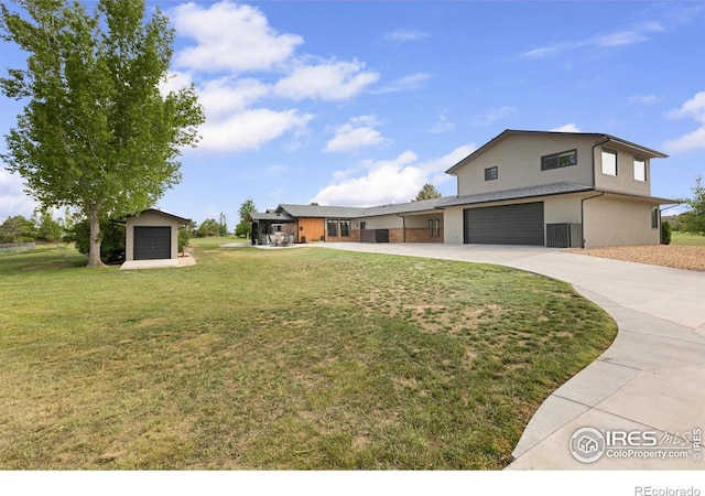 1119 Wrangler Way, Loveland, CO 80537 - view of front of home with an attached garage, driveway, a front lawn, and stucco siding