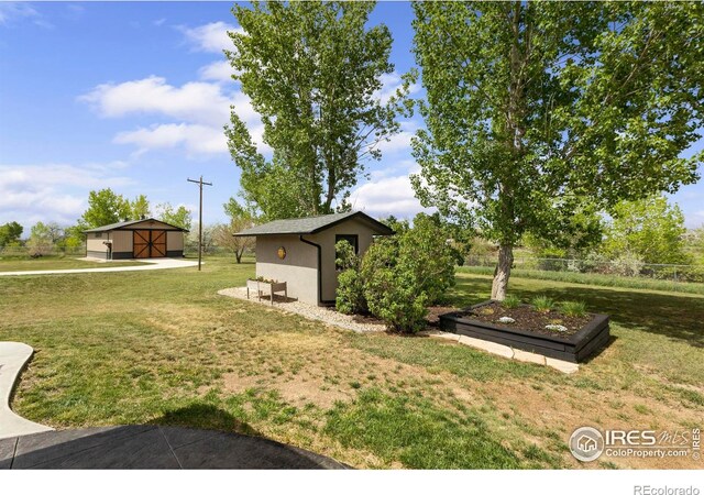 1119 Wrangler Way, Loveland, CO 80537 - view of grassy yard featuring an outdoor structure