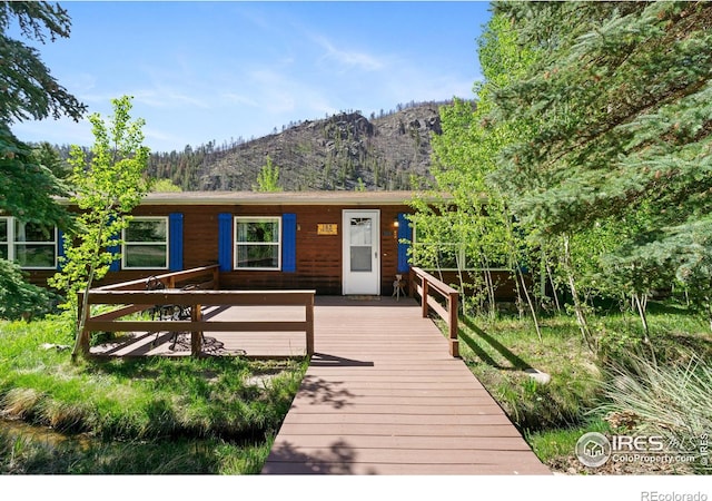 185 Meadow Ln, Bellvue, CO 80512 - ranch-style home with a deck with mountain view