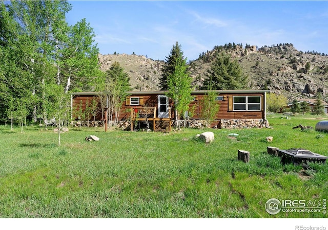 185 Meadow Ln, Bellvue, CO 80512 - rear view of house featuring a lawn and a deck with mountain view