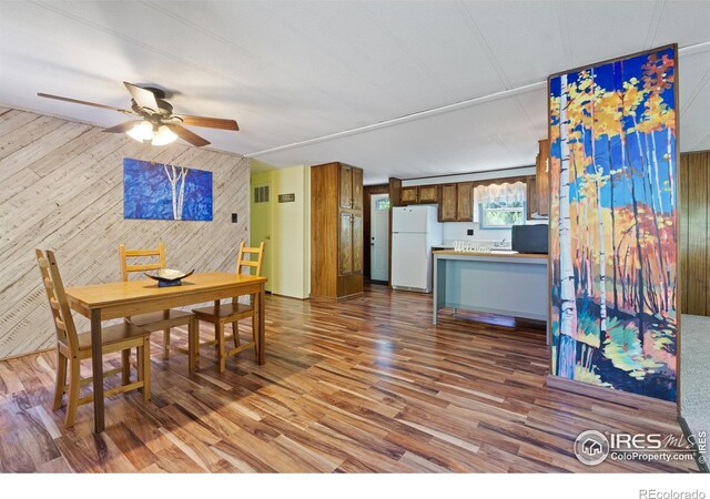 185 Meadow Ln, Bellvue, CO 80512 - dining space featuring wooden walls, wood finished floors, and a ceiling fan