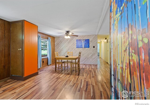 185 Meadow Ln, Bellvue, CO 80512 - dining space featuring ceiling fan, wooden walls, and wood finished floors