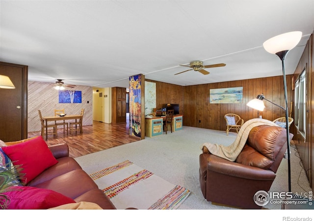 185 Meadow Ln, Bellvue, CO 80512 - carpeted living area with wooden walls and ceiling fan