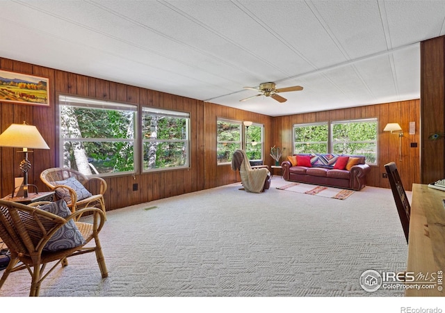 185 Meadow Ln, Bellvue, CO 80512 - carpeted living area featuring a ceiling fan and wood walls
