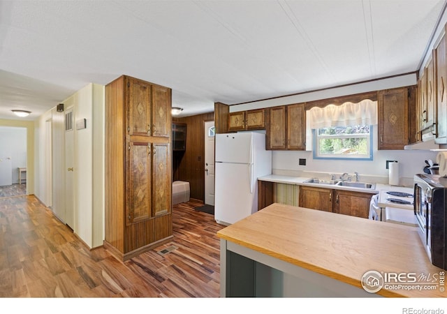 185 Meadow Ln, Bellvue, CO 80512 - kitchen featuring white appliances, a sink, wood finished floors, and brown cabinets