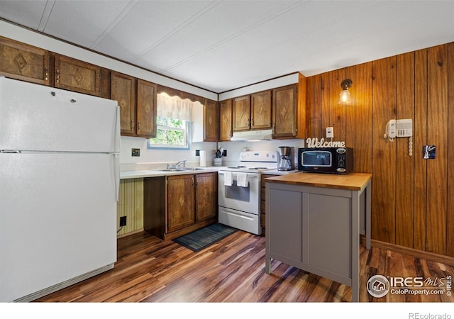 185 Meadow Ln, Bellvue, CO 80512 - kitchen with white appliances, under cabinet range hood, a sink, dark wood-style flooring, and wood counters