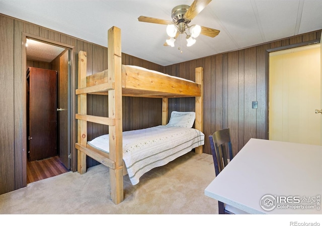185 Meadow Ln, Bellvue, CO 80512 - bedroom featuring wooden walls, carpet floors, and ceiling fan