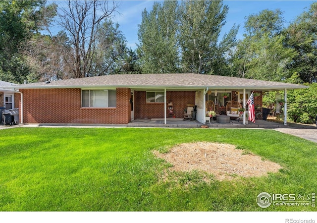 view of front of property with a front lawn and brick siding