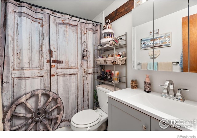 bathroom featuring toilet and vanity