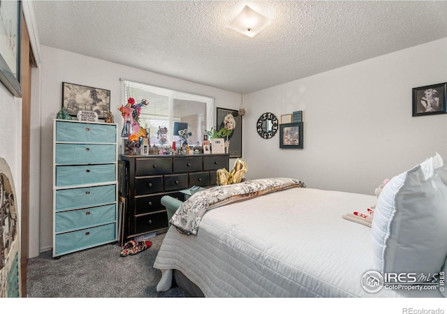 carpeted bedroom with a textured ceiling