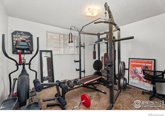 workout area featuring a textured ceiling