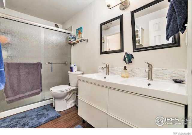 925 Columbia Rd Unit 714, Fort Collins, CO 80525 - full bath with wood finished floors, decorative backsplash, a shower stall, double vanity, and toilet