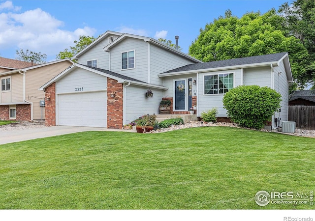 2325 42nd Avenue Ct, Greeley, CO 80634 - split level home with central AC unit, a garage, and concrete driveway