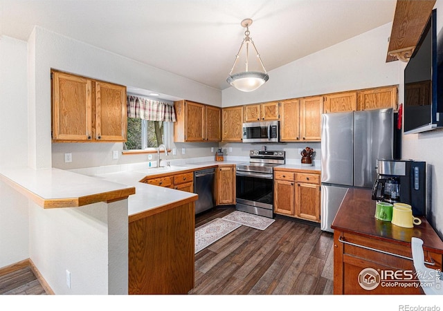 2325 42nd Avenue Ct, Greeley, CO 80634 - kitchen featuring appliances with stainless steel finishes, a peninsula, dark wood-type flooring, light countertops, and a sink