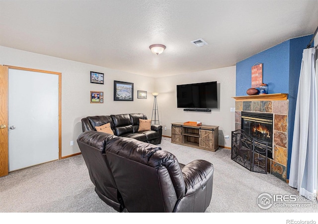 2325 42nd Avenue Ct, Greeley, CO 80634 - carpeted living area featuring a tile fireplace, baseboards, and a textured ceiling