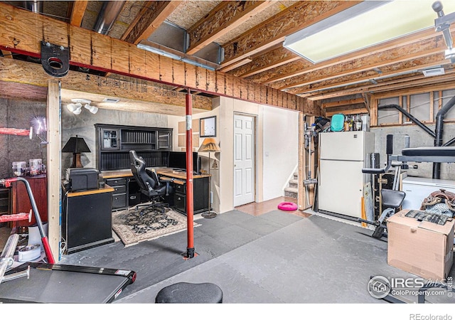 2325 42nd Avenue Ct, Greeley, CO 80634 - unfinished basement with freestanding refrigerator, stairway, and an office area