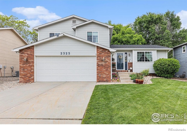 2325 42nd Avenue Ct, Greeley, CO 80634 - split level home with a garage, brick siding, a front yard, and concrete driveway