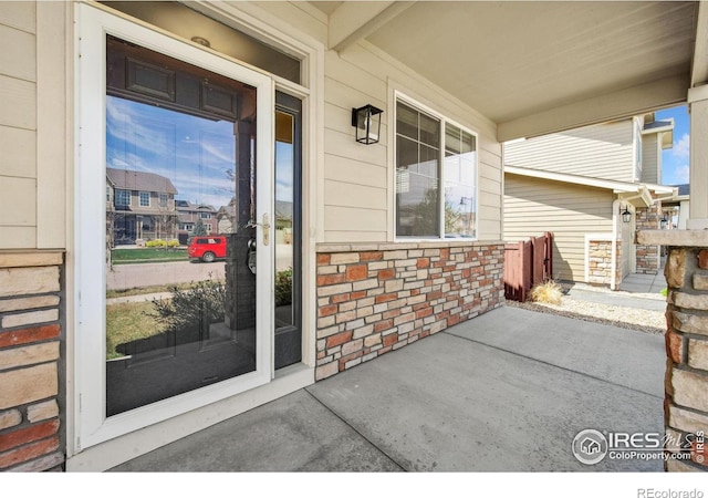 6071 Moran Rd, Timnath, CO 80547 - doorway to property featuring covered porch