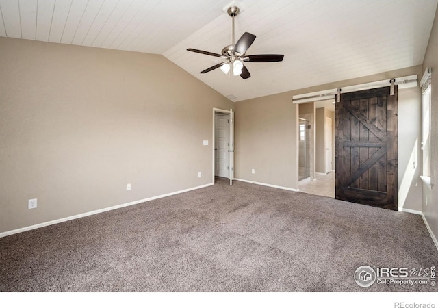 6071 Moran Rd, Timnath, CO 80547 - spare room featuring ceiling fan, lofted ceiling, carpet floors, baseboards, and a barn door