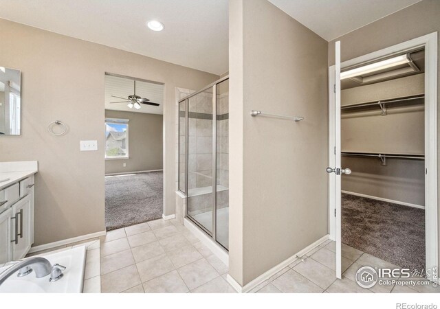 6071 Moran Rd, Timnath, CO 80547 - bathroom with a shower stall, tile patterned flooring, baseboards, a ceiling fan, and vanity
