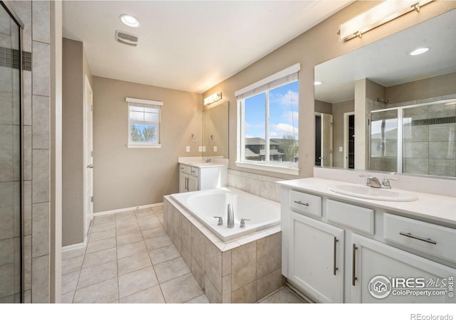 6071 Moran Rd, Timnath, CO 80547 - bathroom with a shower stall, a garden tub, two vanities, tile patterned flooring, and baseboards