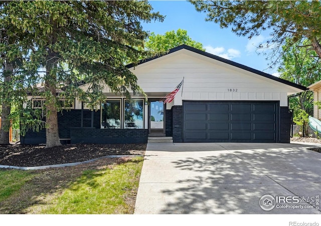 1832 24th Avenue Pl, Greeley, CO 80634 - ranch-style house with driveway, brick siding, and a garage
