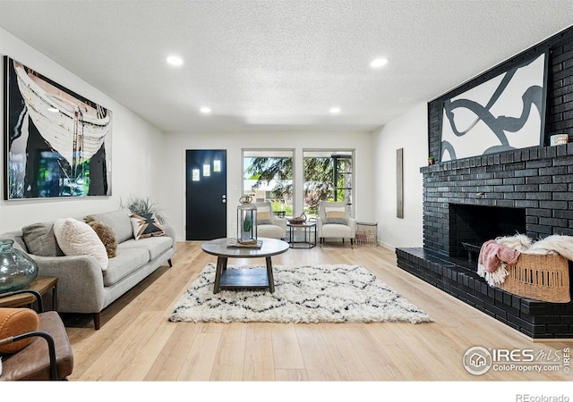 1832 24th Avenue Pl, Greeley, CO 80634 - living area with wood finished floors, recessed lighting, a fireplace, and a textured ceiling