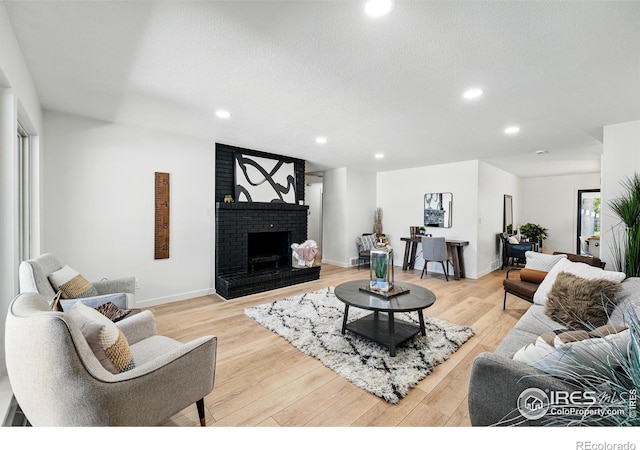 1832 24th Avenue Pl, Greeley, CO 80634 - living area with recessed lighting, a fireplace, light wood finished floors, and baseboards