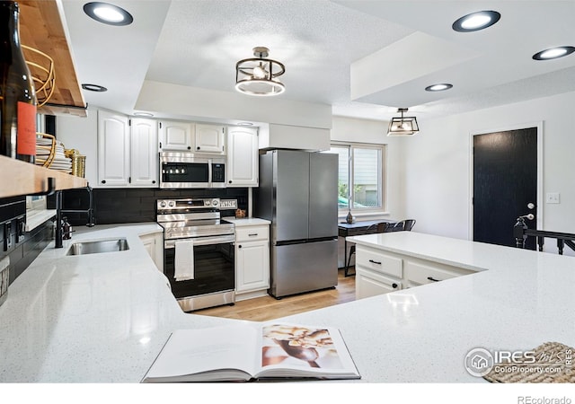1832 24th Avenue Pl, Greeley, CO 80634 - kitchen featuring appliances with stainless steel finishes, a sink, tasteful backsplash, white cabinets, and recessed lighting