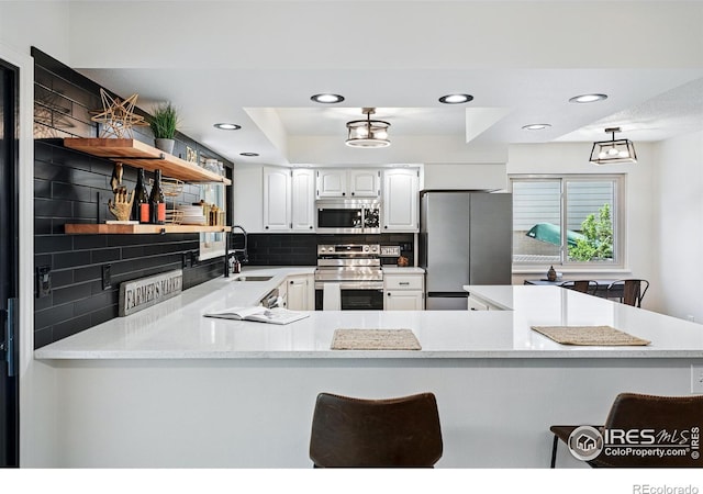 1832 24th Avenue Pl, Greeley, CO 80634 - kitchen with appliances with stainless steel finishes, open shelves, a sink, decorative backsplash, and recessed lighting