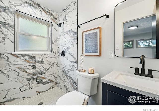 1832 24th Avenue Pl, Greeley, CO 80634 - full bathroom featuring a tile shower, vanity, and toilet