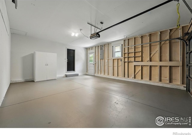 1832 24th Avenue Pl, Greeley, CO 80634 - garage featuring a garage door opener, electric panel, and baseboards