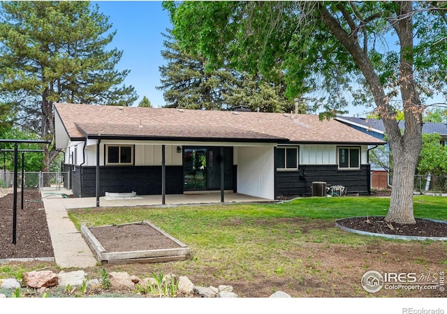 1832 24th Avenue Pl, Greeley, CO 80634 - back of property featuring a patio area, central AC, and a shingled roof