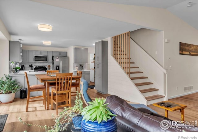 2940 E Yarrow Cir, Superior, CO 80027 - dining room featuring light wood-style floors, stairway, and lofted ceiling