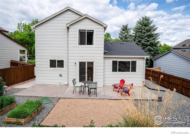 2940 E Yarrow Cir, Superior, CO 80027 - back of property with a patio, a vegetable garden, and a fenced backyard