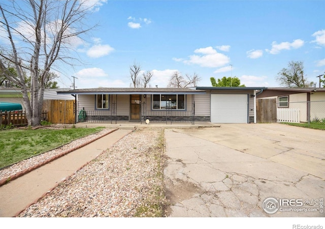 405 16th Ave, Greeley, CO 80631 - view of front of house with a porch, concrete driveway, and a garage