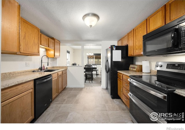 405 16th Ave, Greeley, CO 80631 - kitchen with black appliances, a sink, light countertops, a chandelier, and a textured ceiling