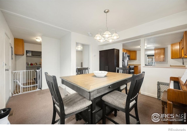 405 16th Ave, Greeley, CO 80631 - dining area with a chandelier, dark colored carpet, and baseboards