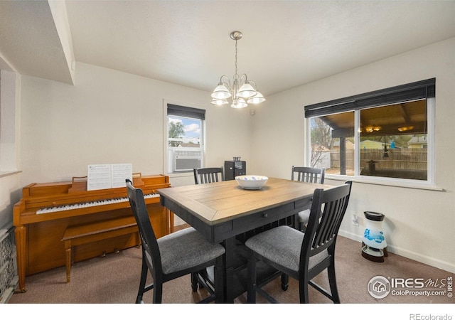 405 16th Ave, Greeley, CO 80631 - dining area featuring carpet, a chandelier, healthy amount of natural light, and baseboards
