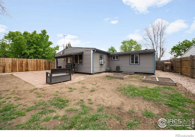 405 16th Ave, Greeley, CO 80631 - back of property with a patio, a fenced backyard, and a garden