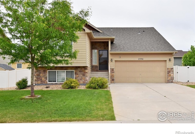 2334 75th Ave, Greeley, CO 80634 - split level home featuring stone siding, driveway, a garage, and roof with shingles