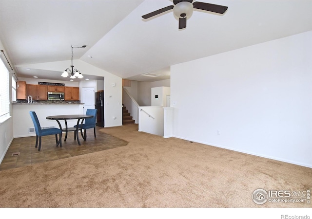 2334 75th Ave, Greeley, CO 80634 - living area featuring carpet flooring, vaulted ceiling, a ceiling fan, baseboards, and stairs