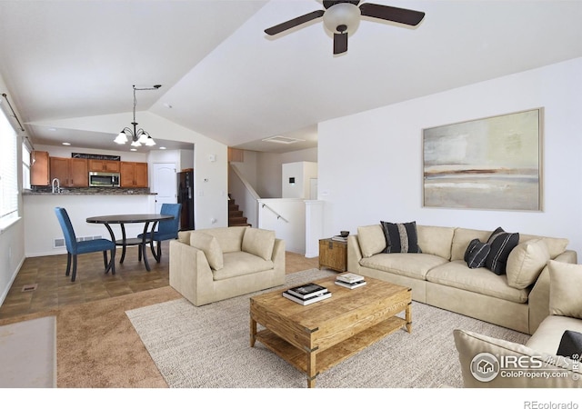2334 75th Ave, Greeley, CO 80634 - living room featuring lofted ceiling, a ceiling fan, stairway, and a chandelier