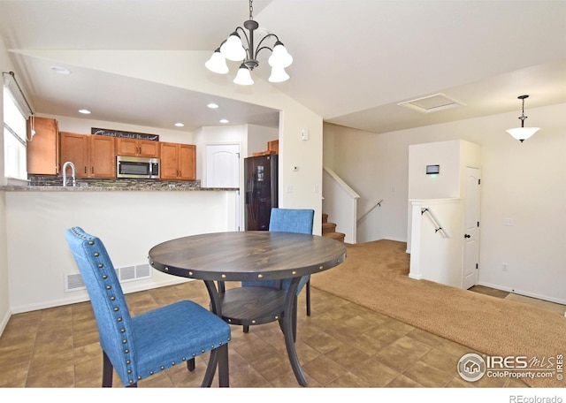 2334 75th Ave, Greeley, CO 80634 - dining area featuring a chandelier, vaulted ceiling, and recessed lighting