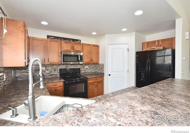 2334 75th Ave, Greeley, CO 80634 - kitchen with black appliances, a sink, tasteful backsplash, brown cabinetry, and recessed lighting