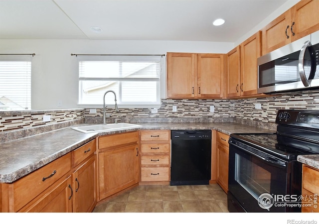 2334 75th Ave, Greeley, CO 80634 - kitchen featuring black appliances, a sink, tasteful backsplash, and dark countertops