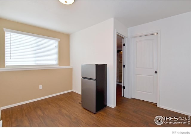 2334 75th Ave, Greeley, CO 80634 - kitchen with freestanding refrigerator, wood finished floors, and baseboards