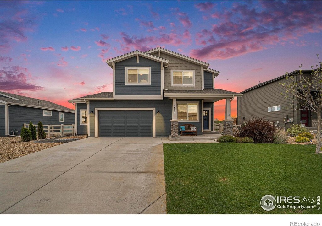 7535 Horsechestnut St, Wellington, CO 80549 - view of front of home with covered porch, a garage, and driveway